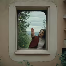 an image of a woman that is looking outside the window