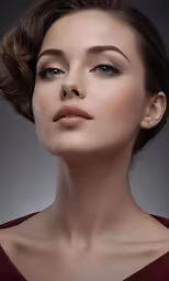 an elegant woman with pale makeup looks straight ahead
