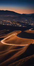 a long road winding down a hillside in the night
