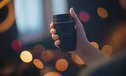 a person holding a cell phone and a camera