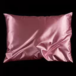 pink silk pillow with satin lining and a black background