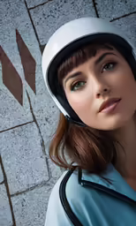 woman in sky blue top with motorcycle helmet