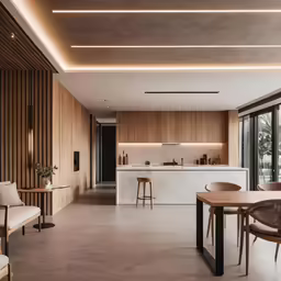 a kitchen, dining room and living area with modern lighting