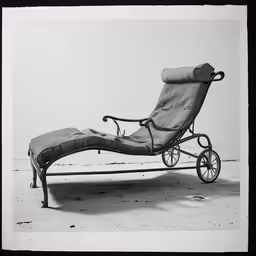 a buggy with wheels attached to it and an ottoman on one leg