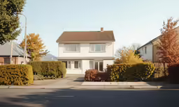 the front of an english style white house with a driveway in front