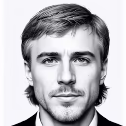a man that has a suit on and tie on