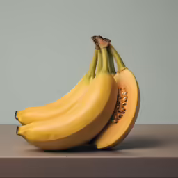four ripe bananas sitting on top of each other