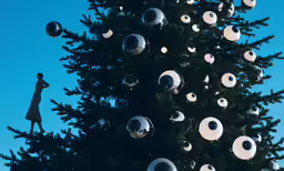 there is a large tree that has been decorated with balls