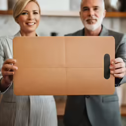 a man and a woman show off their new ipad cases