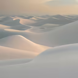 desert area with sand dunes, blue sky, and low clouds