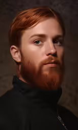 a man with a red beard wearing a black suit
