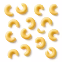 six yellow pasta rings arranged in several different shapes