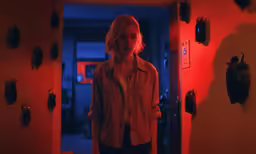 woman standing in doorway at light colored area