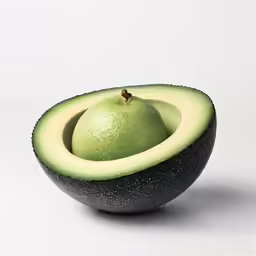 an avocado and a lime are cut in half