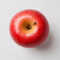an apple has a small bite out of it