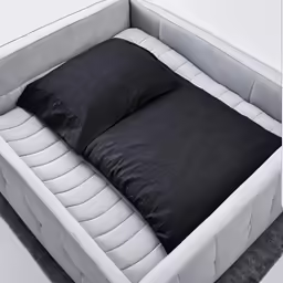 a mattress with two pillows sitting on it