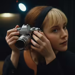 a woman is holding a camera over her eyes