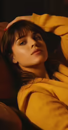 a woman laying on a couch with a long hair