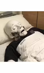 the man is asleep wearing a star wars helmet