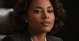 a woman is making a goofy face and looking away from the camera