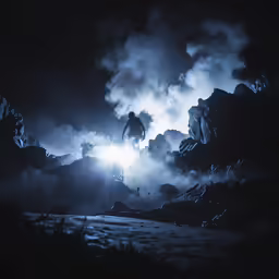 a man standing on a hill in the middle of fog