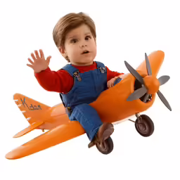 a young boy sitting on top of an orange plane
