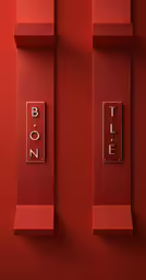 a red wall with two switches mounted on it