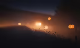 several different lights in the fog on a dark day
