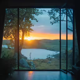 a sunset view of a body of water seen from a window
