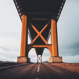 an image of a big bridge going over the road