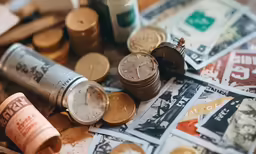 many different types of currency and old watches
