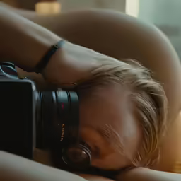 a young woman is taking a picture of herself while in bed