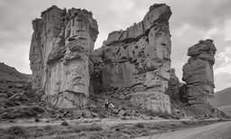 a black and white photo of an area with tall rock formations