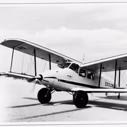 black and white photograph of an airplane on a runway
