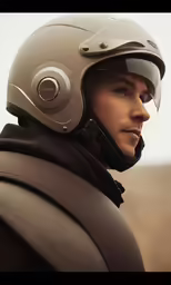 man wearing helmet looking off into the distance