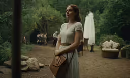 woman in long dress looking away from camera