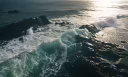 the sun shines bright on the ocean and rocks