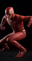 a man in a red outfit crouching down with his legs spread
