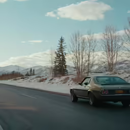 an old green car is on a road