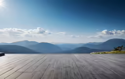 an empty outdoor area overlooks mountains in the distance