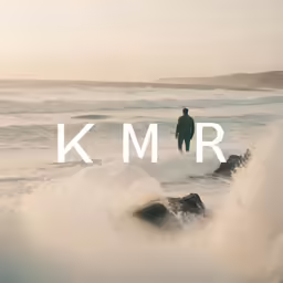 a man walking on a rock toward the ocean