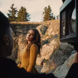 a girl is taking pictures while standing next to someone with a camera