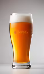 a glass with a light colored beverage sitting on a table