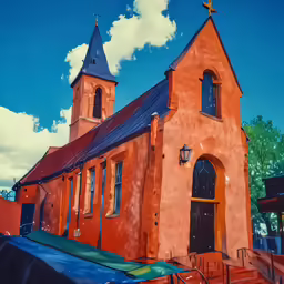 a red church sits against a blue sky