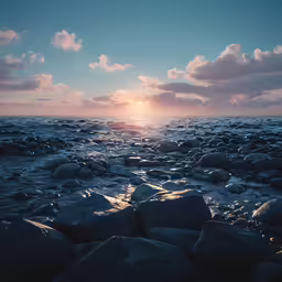 rocks sitting on top of the ocean under cloudy skies