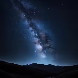 a milky filled with stars above the mountains
