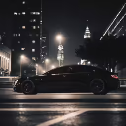 a black car on a city street at night