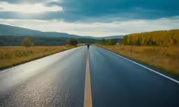 a man is walking down the road near a highway