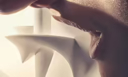 a woman licking her lips out and looking at a white sculpture