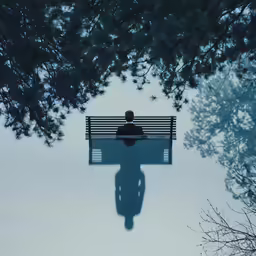 the man is standing on a park bench
